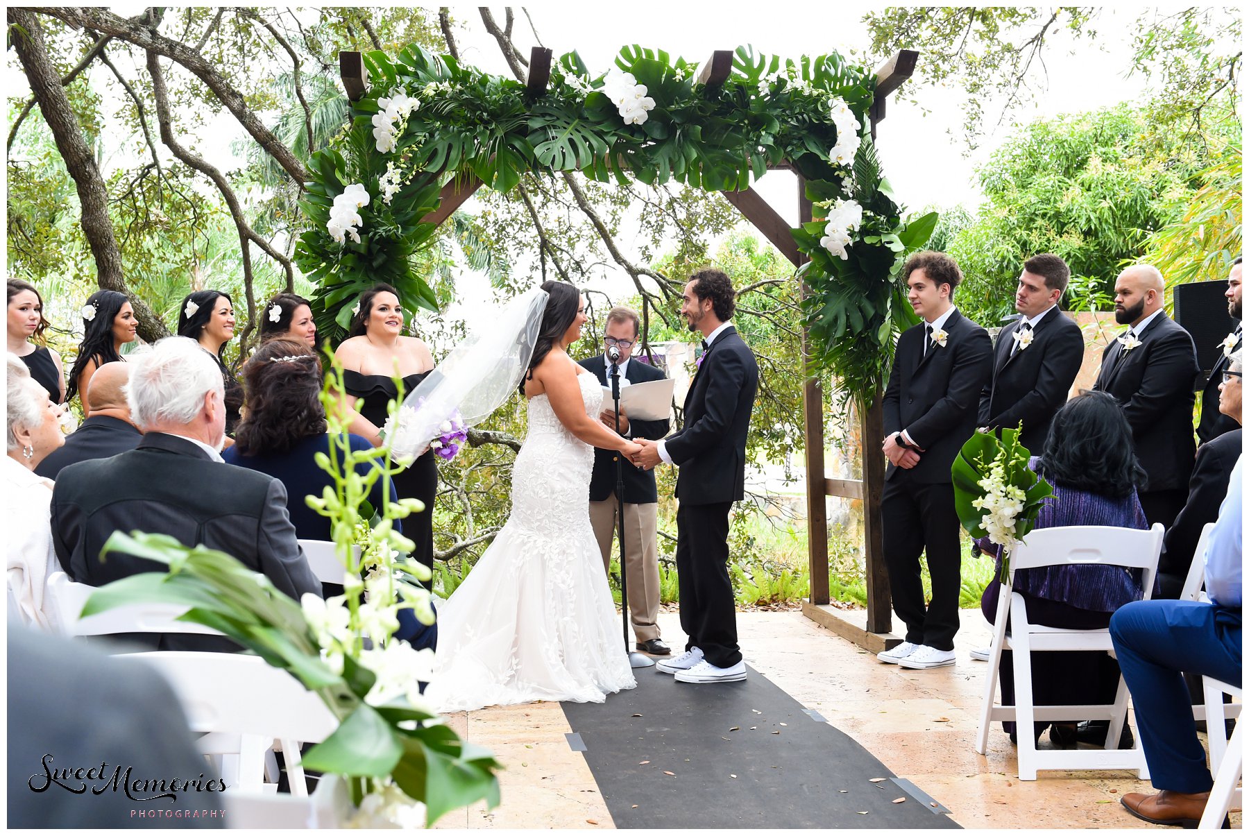 Tropical yet classic, Janice and Michael's Living Sculpture Sanctuary wedding in Davie was the perfect mix of romantic, hilarious, fun, sweet, and chic! After having met at a restaurant, his persistence, and a romantic proposal at the Flamingo gardens, they are now ready to tie the knot!