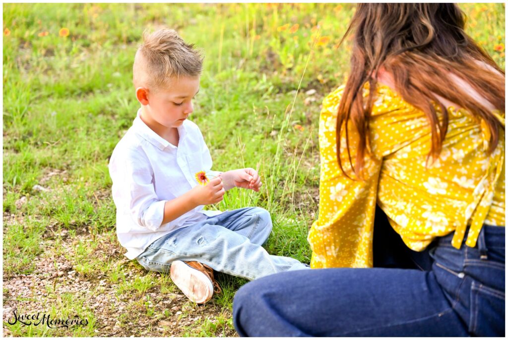 Picking flowers for his mom while she tied his shoes.