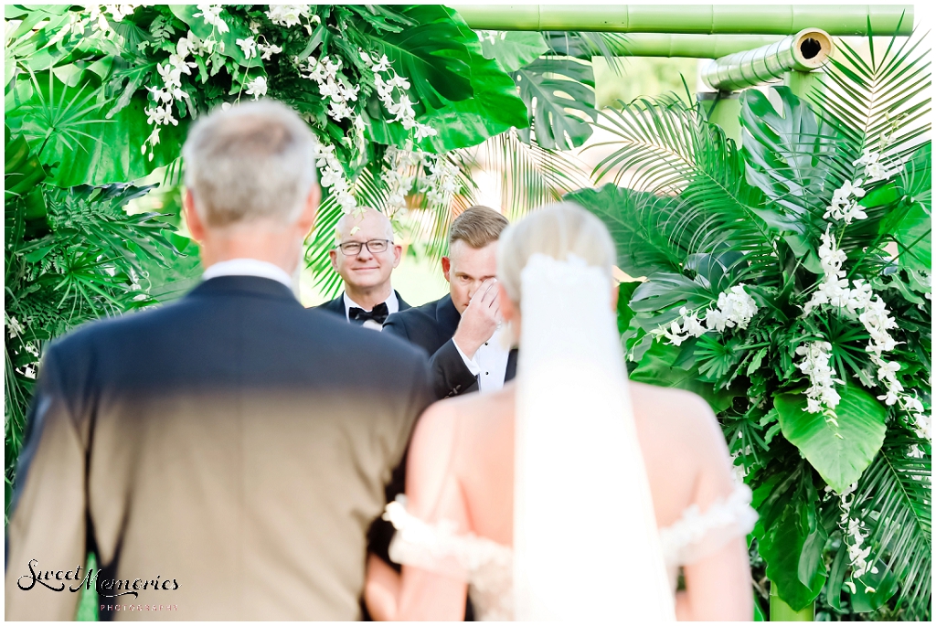 Shedding a few happy tears as the bride comes down to meet him