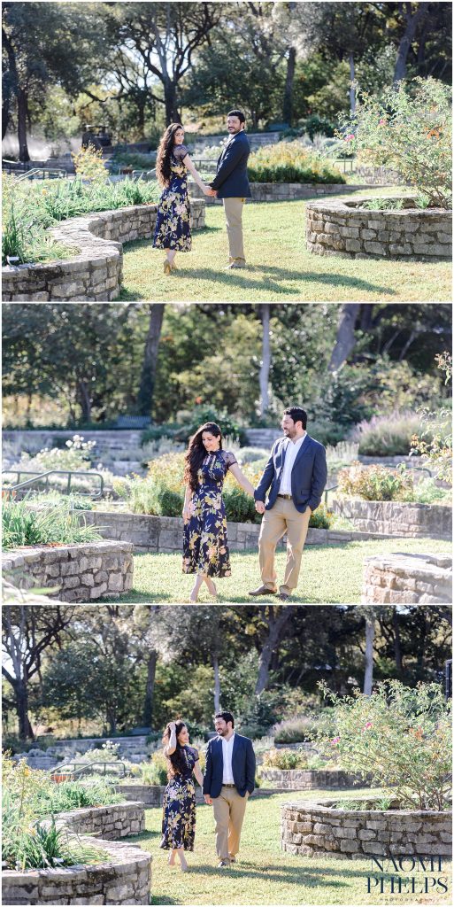 The couple holding hands and walking through the rose garden at zilker botanical garden