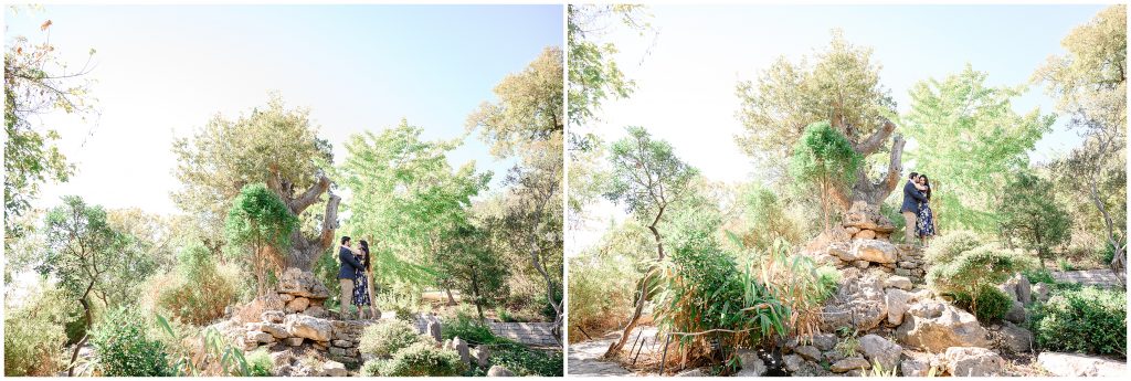 Couple standing on top of rocks at Zilker botanical garden while Austin Texas Photographer stands below