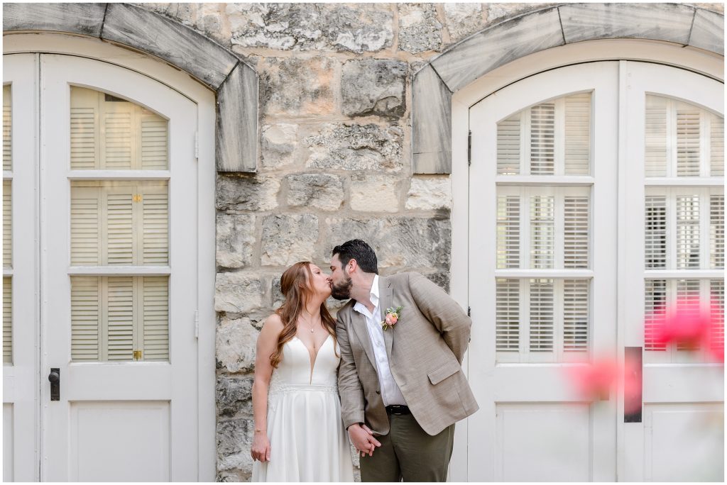 The bride and groom kissing outside of the Downtown Austin wedding venue.