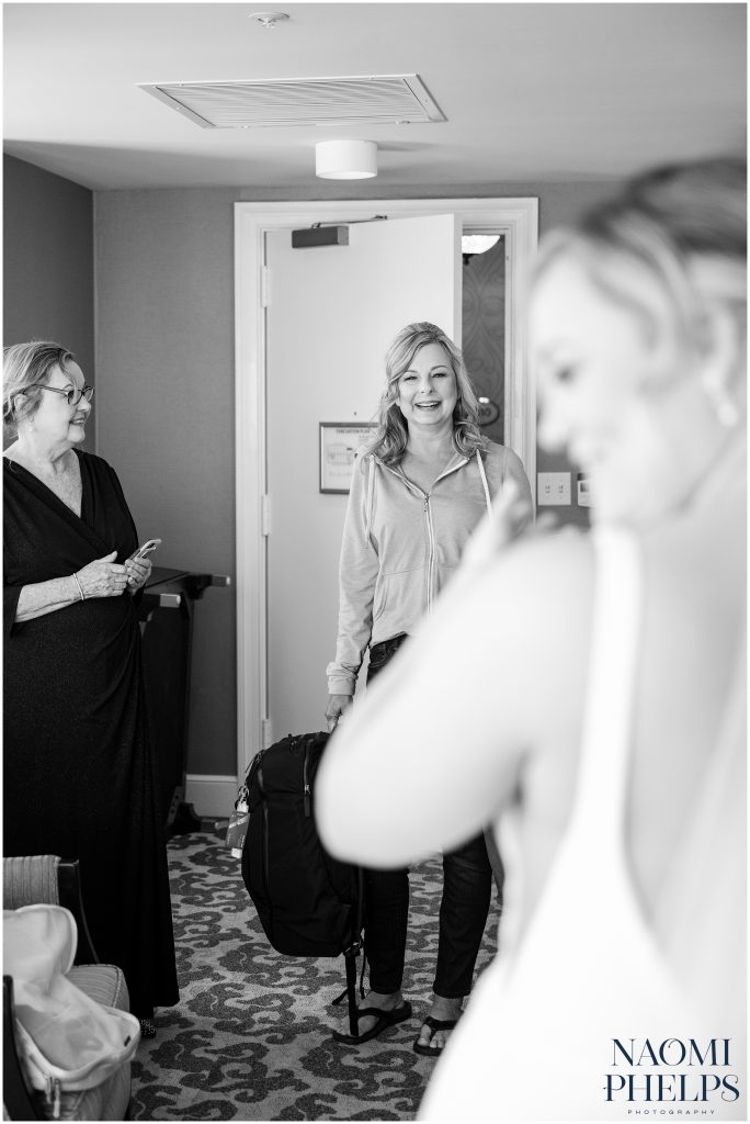 The mother of the groom checking in on the bride in her hotel room.