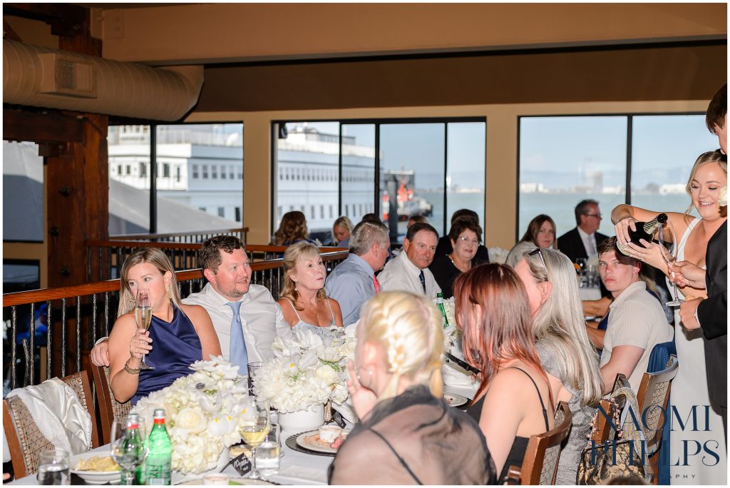 The wedding guests enjoying their meal at the reception.