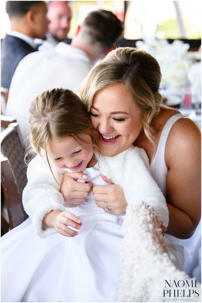 The bride tickling the flowergirl at her San Francisco City Hall wedding reception.