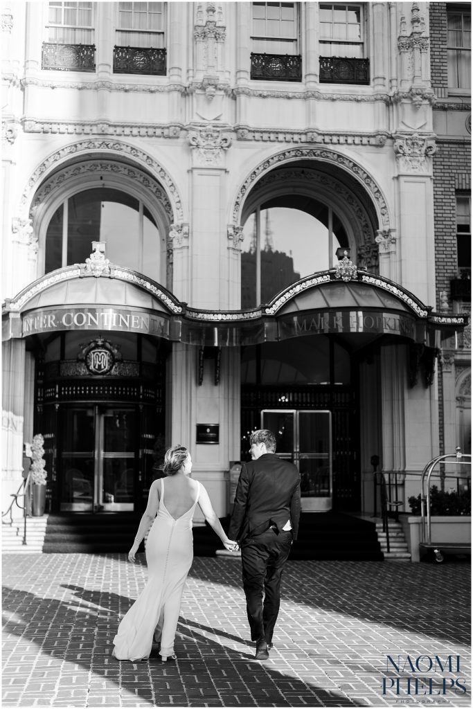 The couple walking into the hotel after their San Francisco city hall wedding.