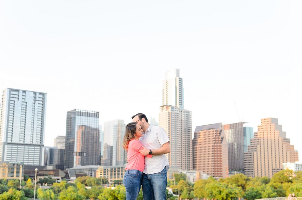 Couple hugging at Auditorium Shores for engagement photos in downtown Austin, TX.