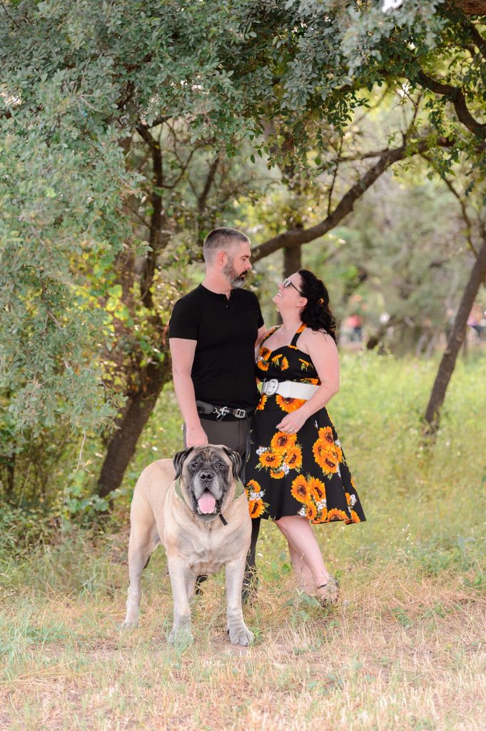 Engaged couple and their dog posing at Brushy Creek Park in Austin, TX.
