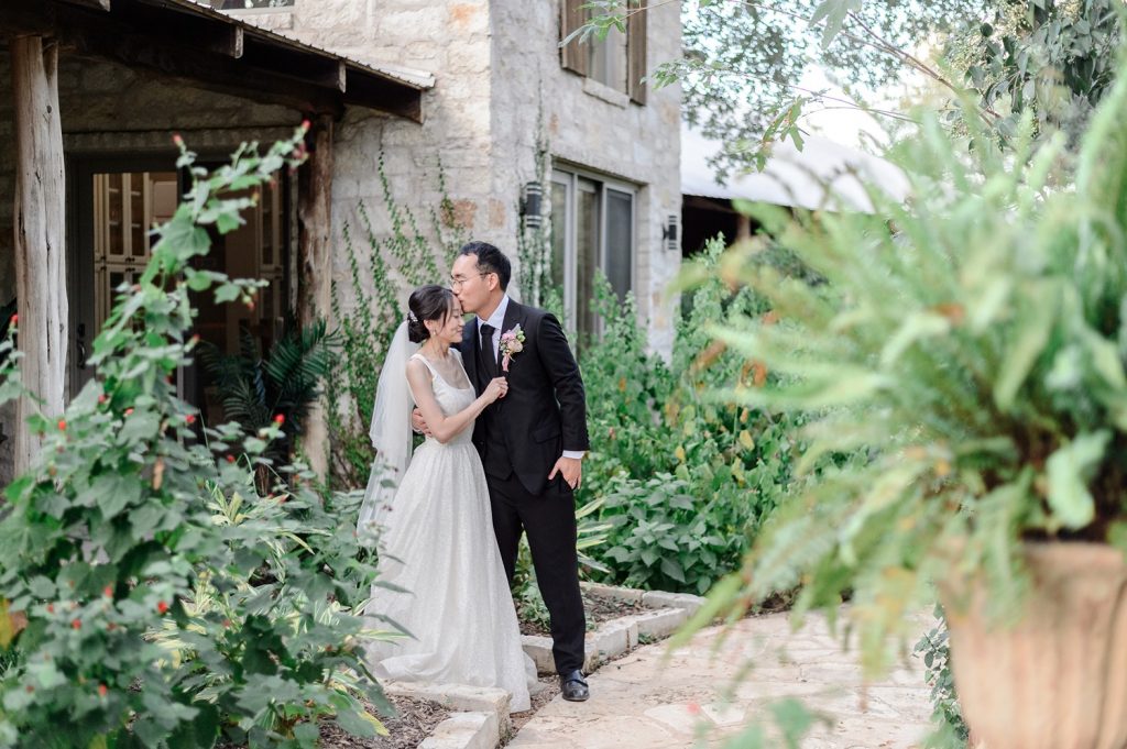 Groom kissing his bride on the forehead at Hudson Bend Ranch, a small wedding venue in Austin TX.