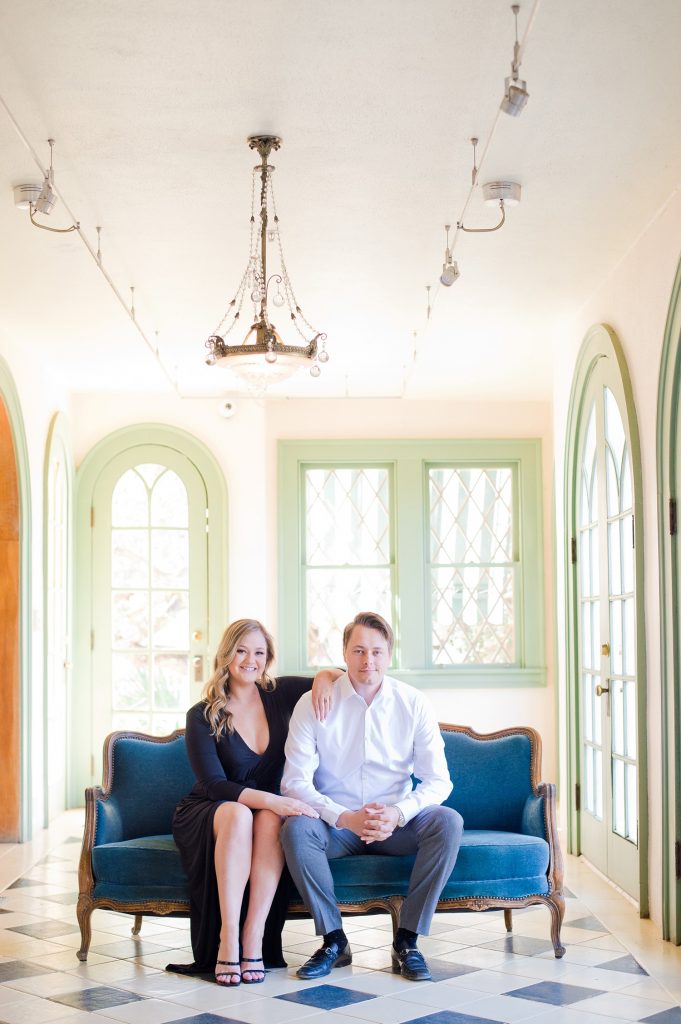 Engaged couple sitting on a blue settee at Laguna Gloria in Austin.