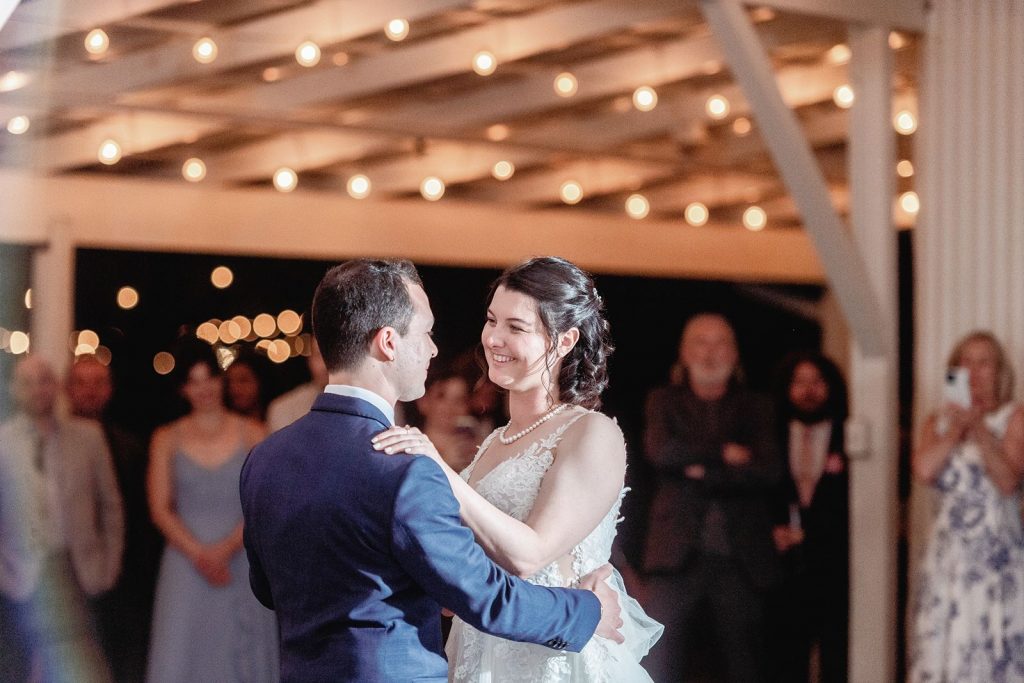 Bride and groom dancing for the first time as newlyweds at Pecan Springs Ranch wedding reception.