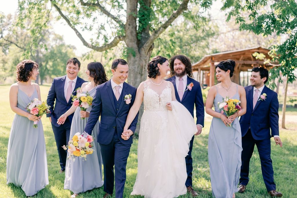 Bride and groom walking with their bridesmaids and groomsmen before their Austin wedding ceremony.
