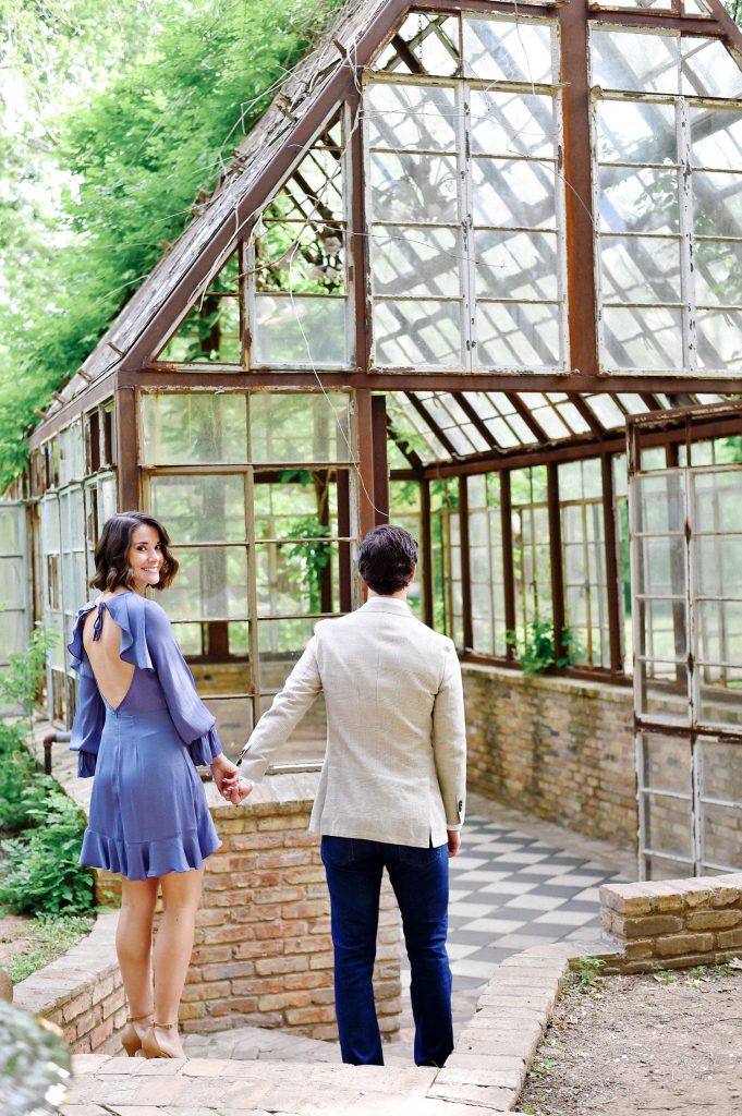 Couple walking towards the greenhouse at Sekrit Theater, a small wedding venue in Austin TX.