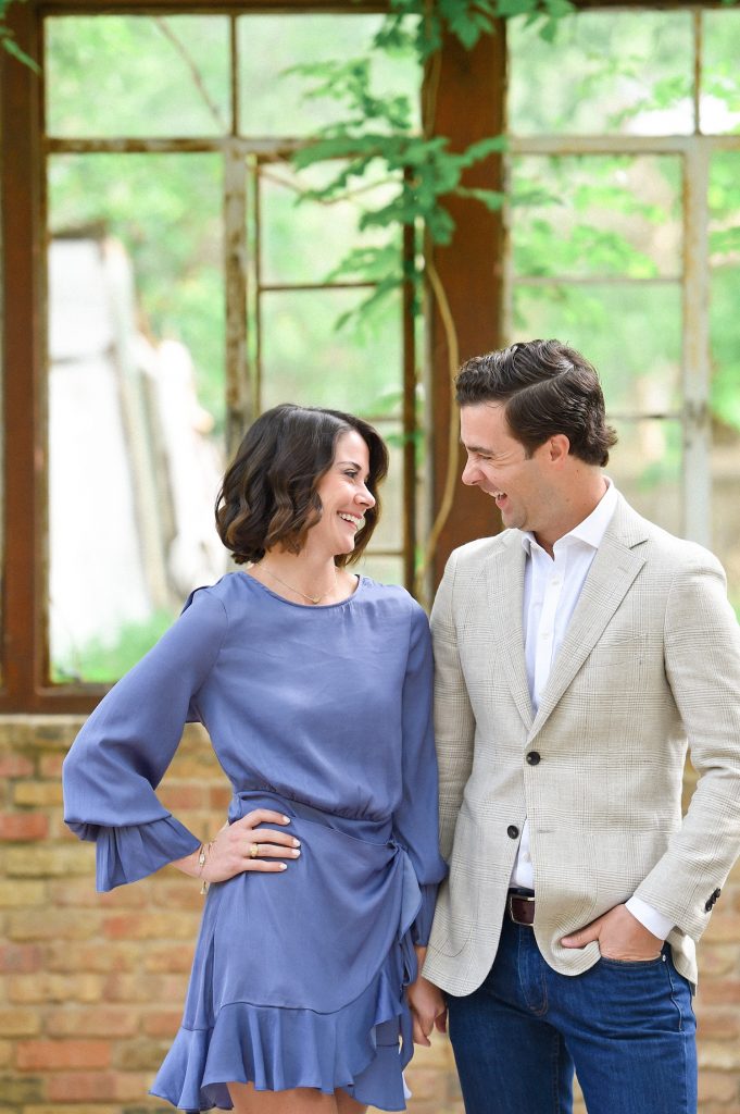 Couple smiling at each other at inside the greenhouse at Sekrit Theater.