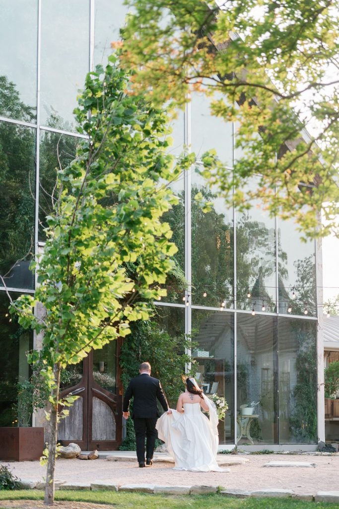 Newlyweds walking to their Barr Mansion wedding reception.