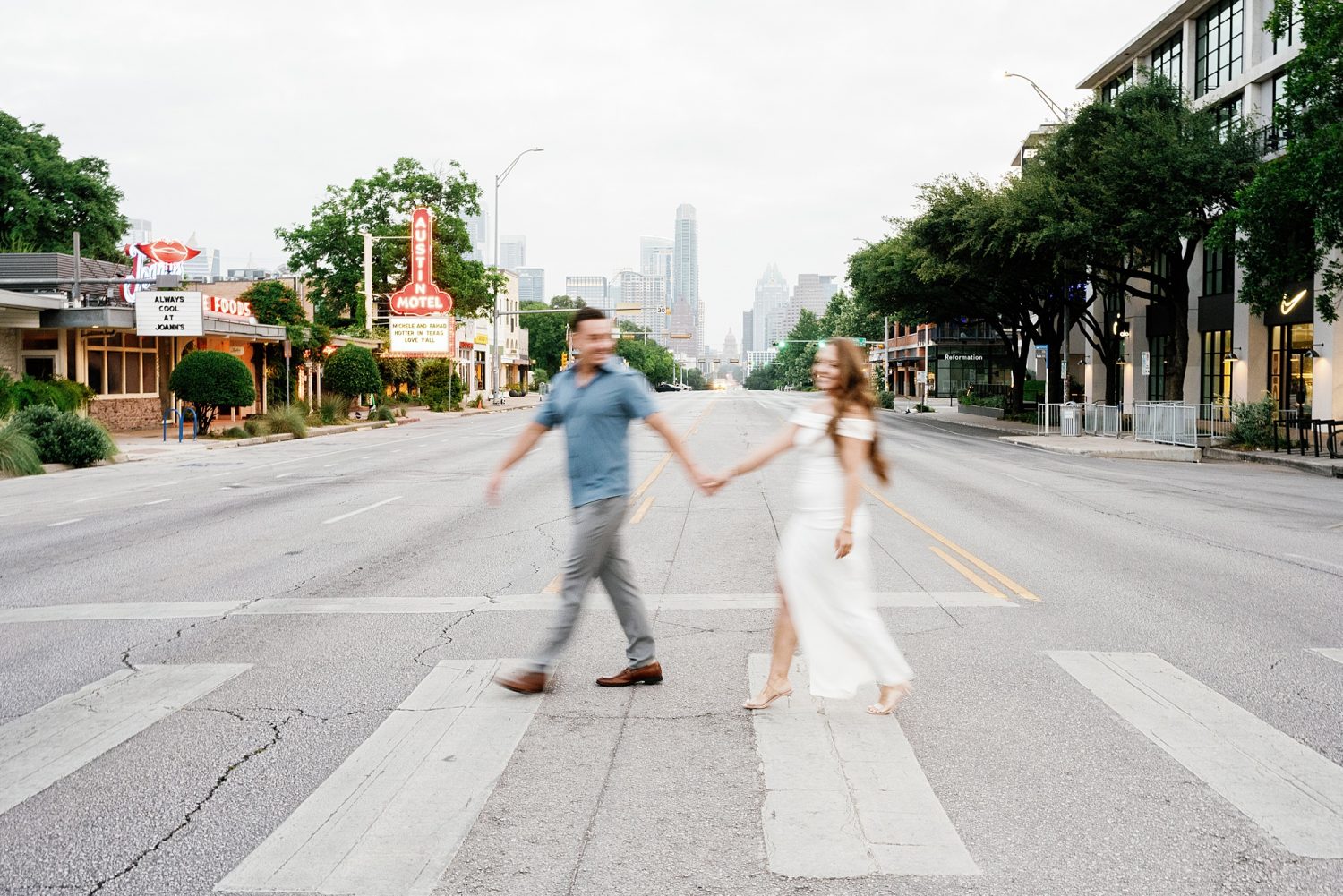 Engagement photos walking across South Congress in downtown Austin