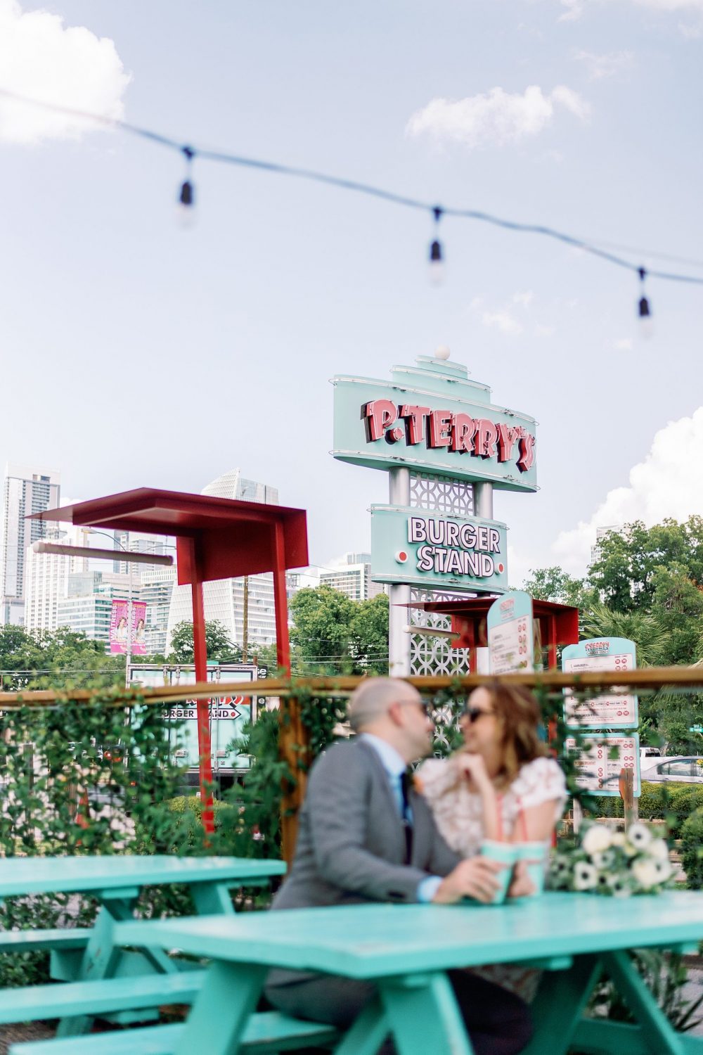 Newlywed couple sitting at picnic table at P. Terry's