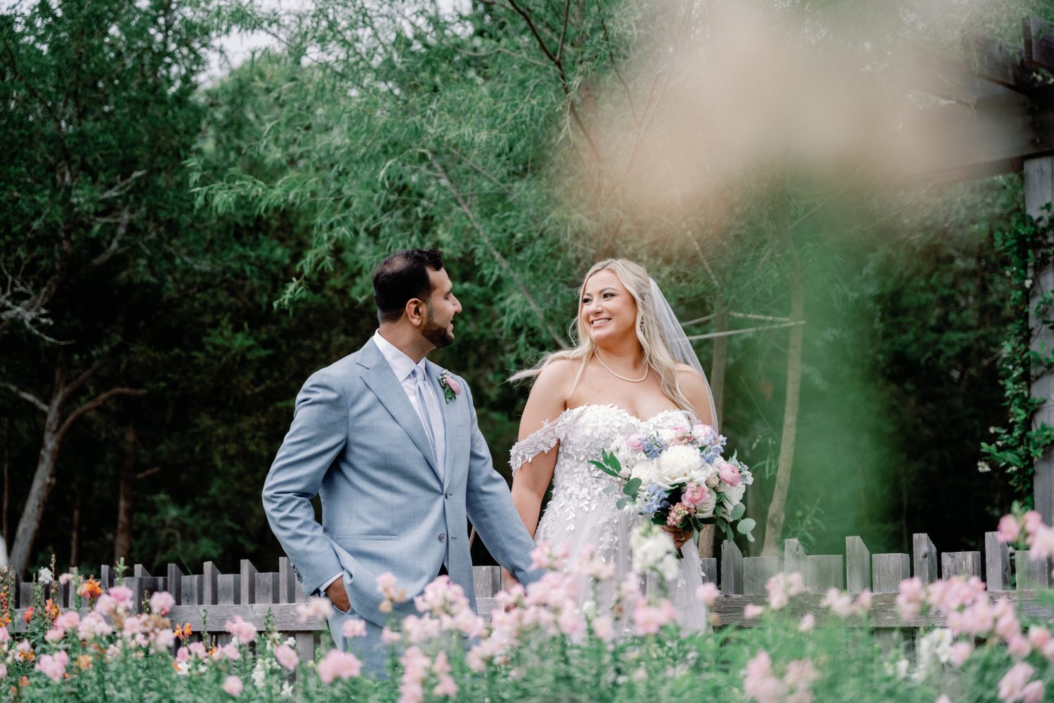 Bride and groom walking by the awning in the garden at The Grand Lady in Austin TX