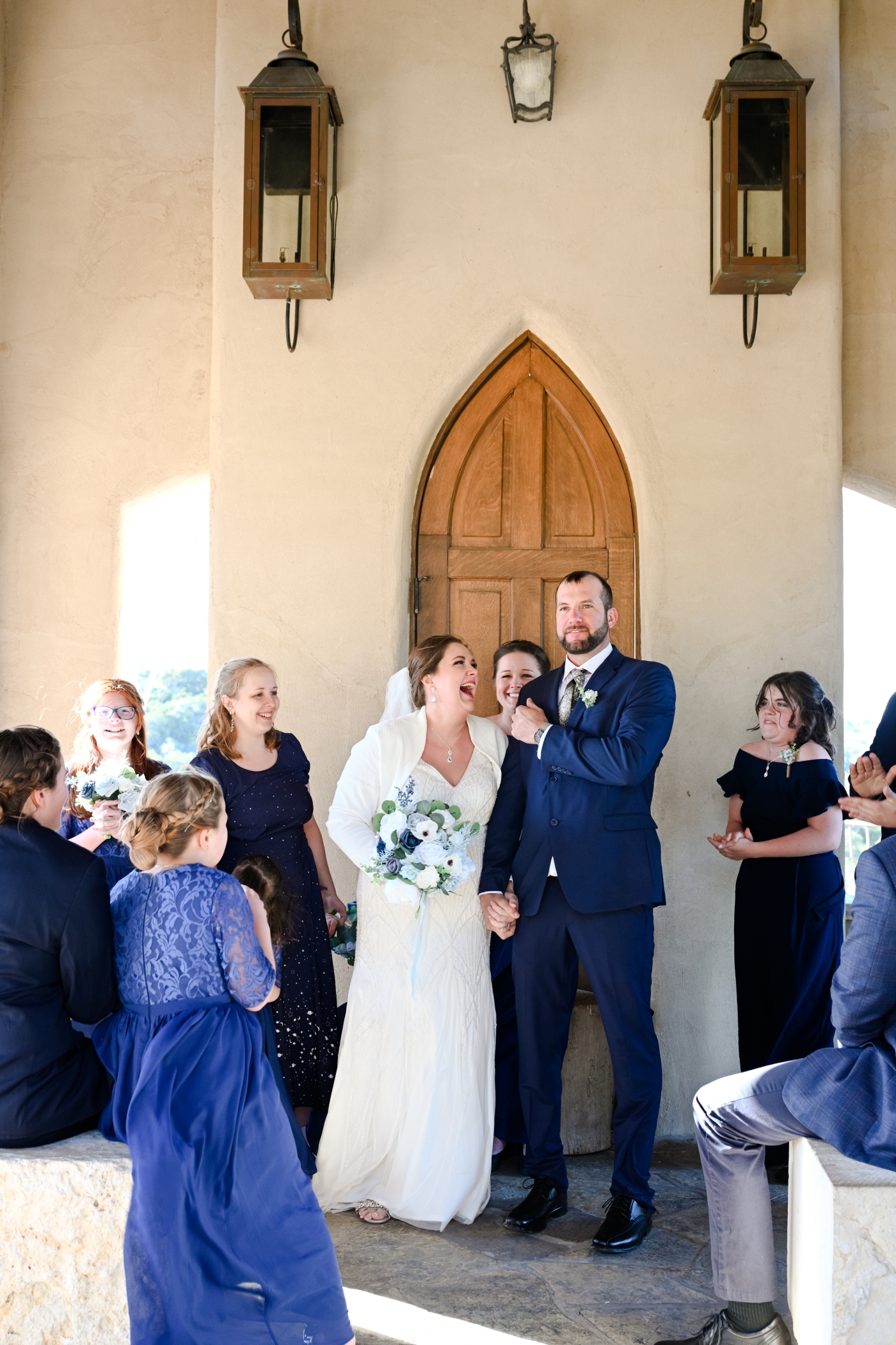 A bride and groom smile as they are announced husband and wife during a micro wedding ceremony